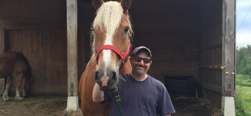 Josh, a rural small business owner, enjoys time with his horse.