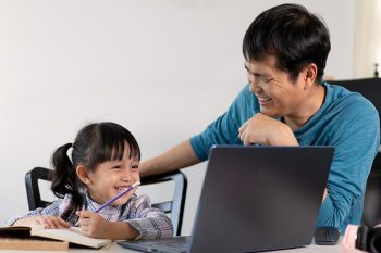 father helping daughter with online learning