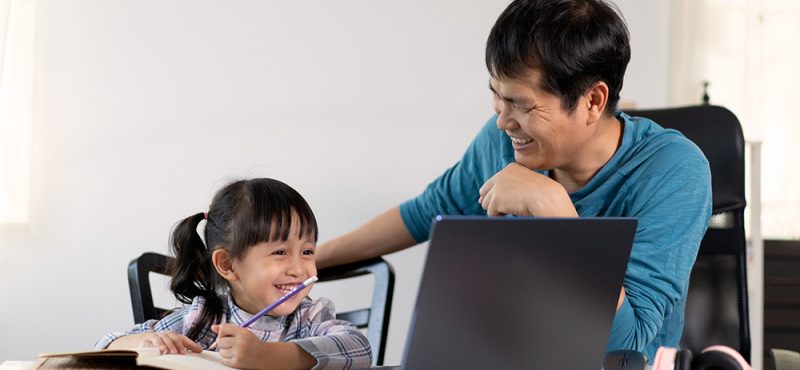 father helping daughter with online learning