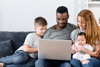 family using laptop together at home