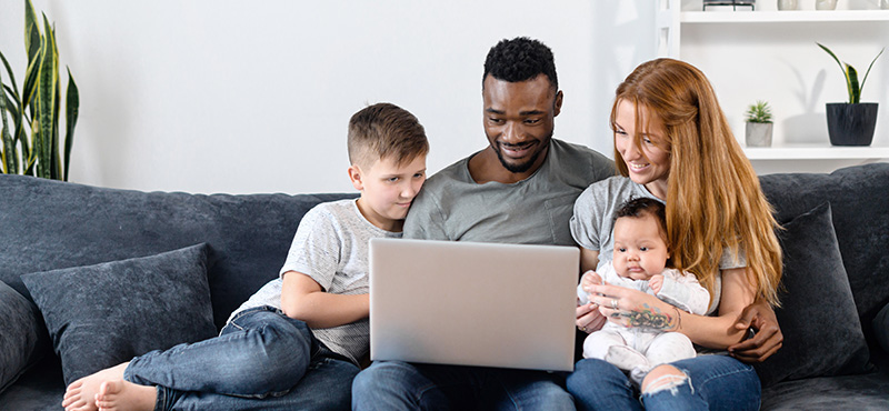 family using laptop together at home