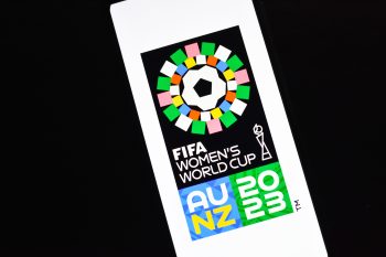 Selective focus of FIFA Women's World Cup logo on a smartphone screen stock image.