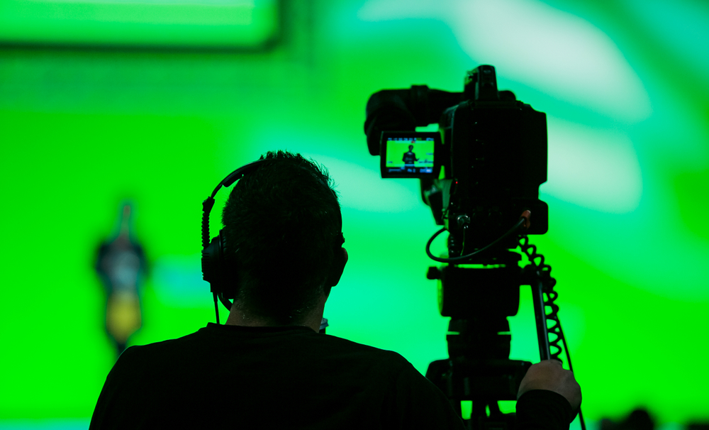 Silhouette of a Cameraman and Video Camera at live broadcast news event